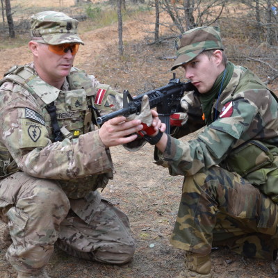 Frenchy Instructing Latvian Soldier in Basic Rifle Marksmanship, Latvia 2014